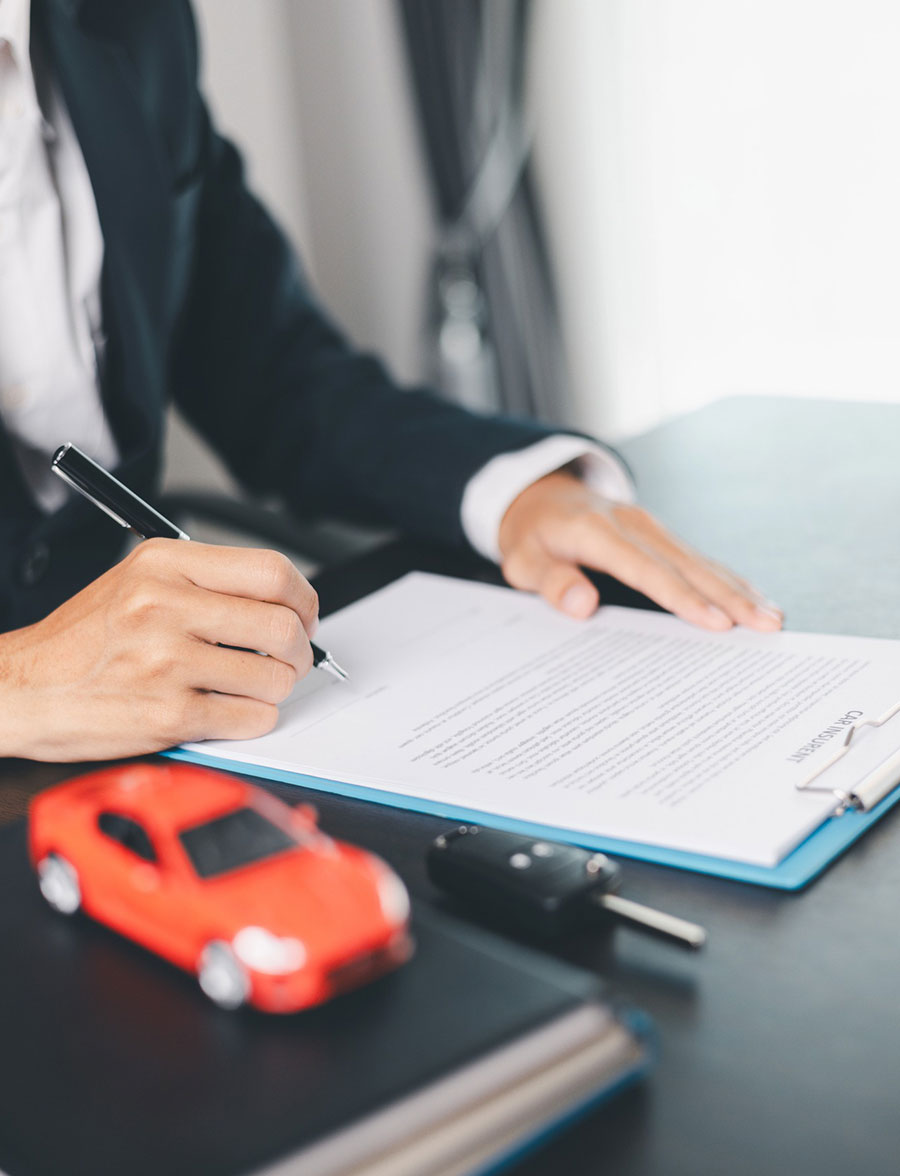 Hand reviewing car ownership documents and license plates